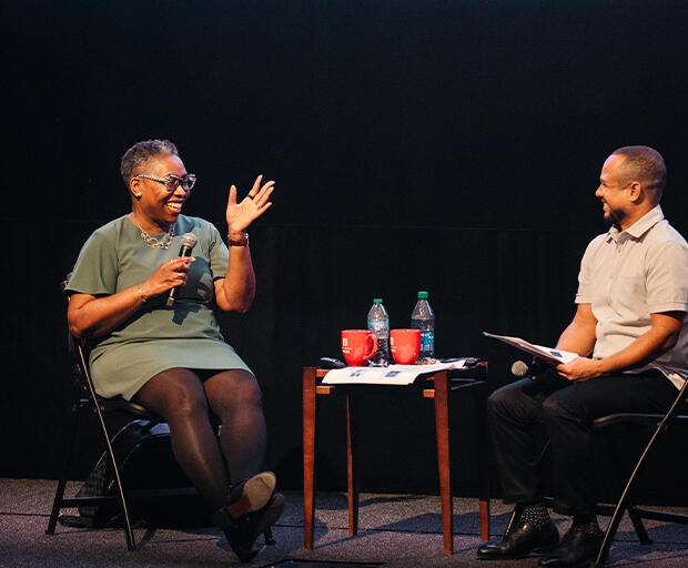 Novotny Lawrence and Robin R. Means Coleman sit on the stage and speak to audience.