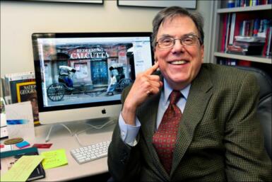 Steve Raymer sitting at a desk in front of a computer