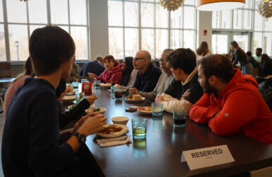 A group of people eat dinner at a table.