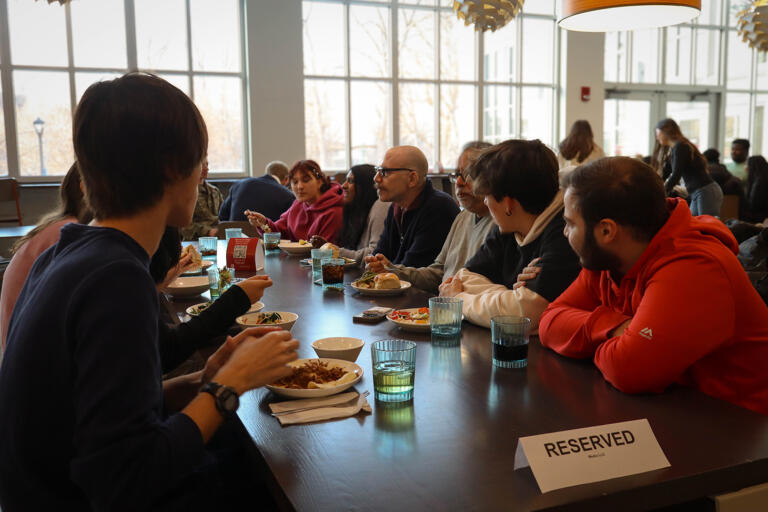 A group of people eat dinner at a table.