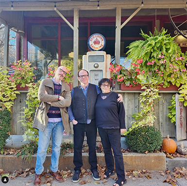 David Tolchinsky, Jon Edelson, and Rebecca Edelson stand together for a photo.