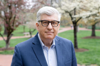 Headshot of James Shanahan with greenery in background.
