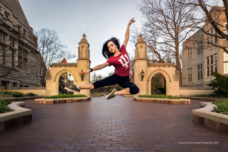 Person jumps in front of the Sample Gate and extends arms and legs mid-air.