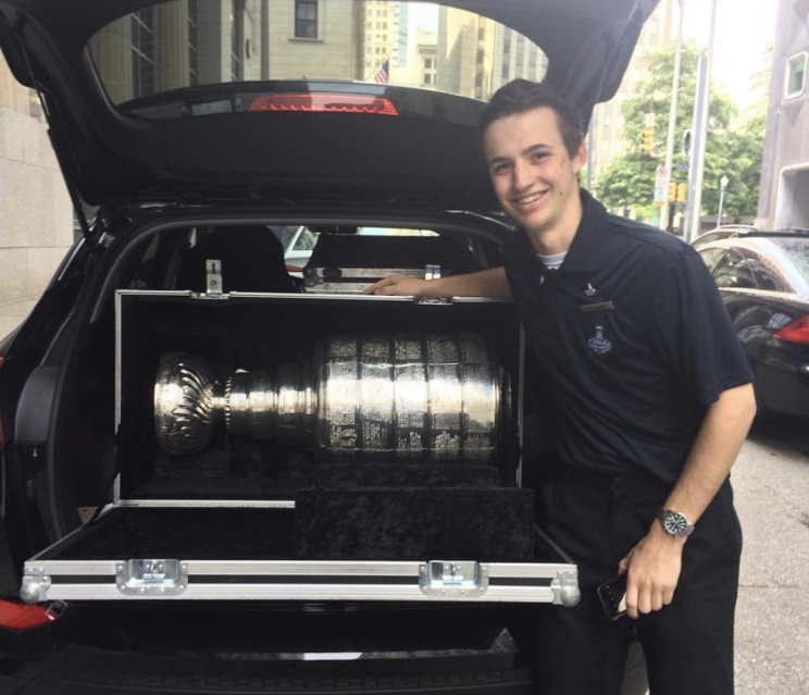 Fuller showing off the Stanley Cup in the trunk of a car.