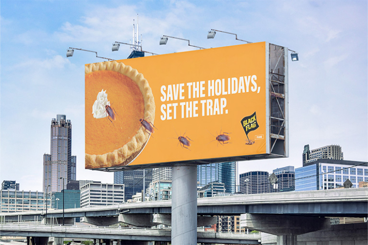 Out of home billboard ad with a photo of pumpkin pie and roaches crawling over the pie. The text reads "Save the Holidays, Set the trap."